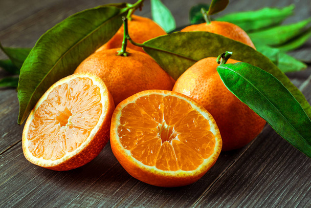 Fresh oranges on a wooden table - Zdjęcie, obraz