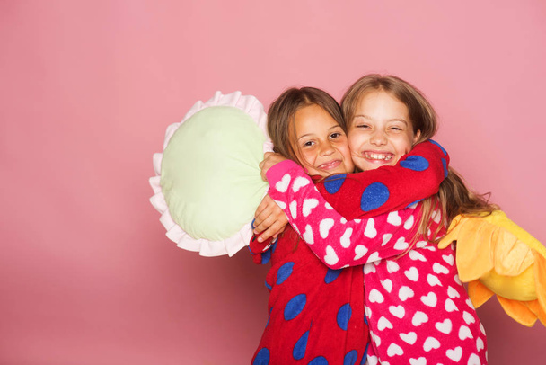 Children with happy faces and loose hair hug - 写真・画像