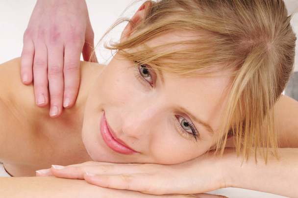 blond woman receives a relaxing massage - Фото, зображення