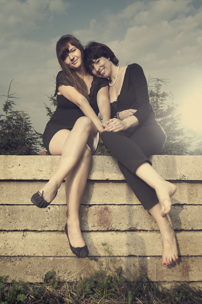 Two friends sitting on a concrete slab - Valokuva, kuva