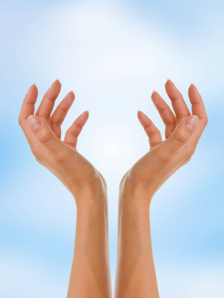 hands of women holding a hand on the sky background - Valokuva, kuva
