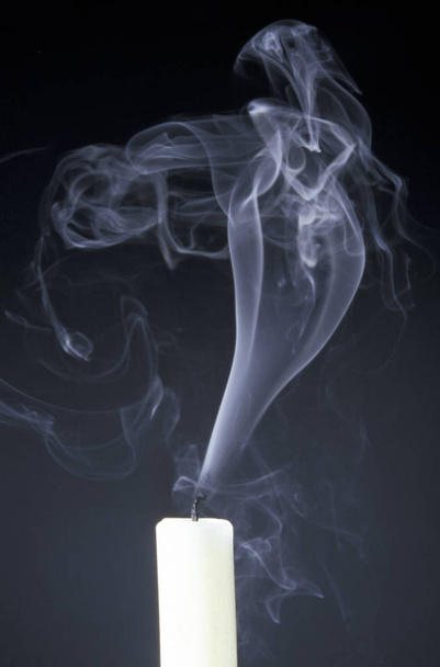 burning candle on black background - 写真・画像