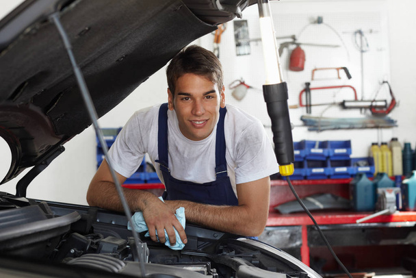 mechanic in uniform working in garage - Фото, изображение