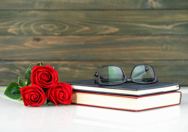 Red roses on table and book with copy space - Photo, Image