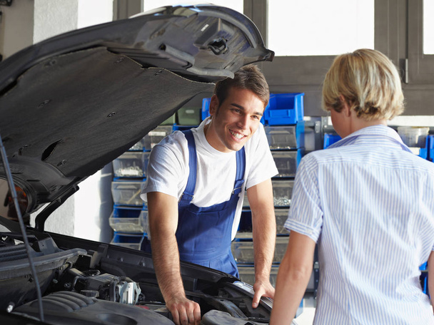 mechanic and apprentice are working together in auto repair shop - Photo, Image