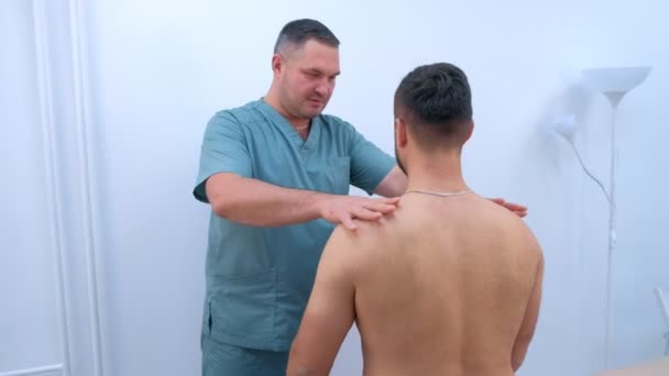 Doctor chiropractor treats patients hands in clinic on rehabilitation therapy. - Imágenes, Vídeo