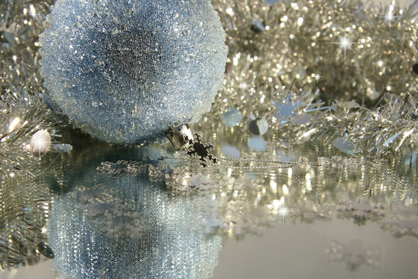 Blue ice Christmas ball with tinsel  - 写真・画像