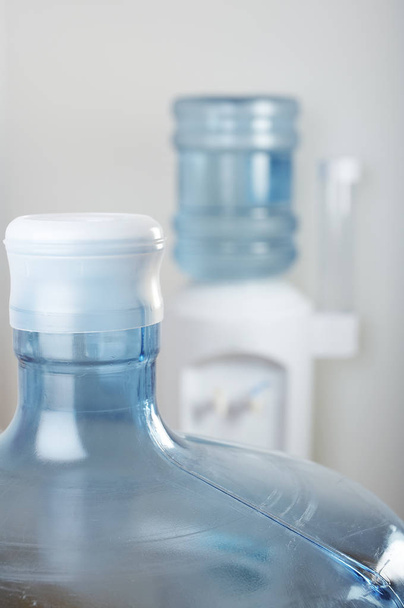 Empty water bottle front of office water cooler - Foto, Imagem