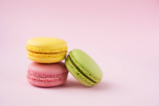 Pink, green and yellow macarons on pink - Foto, imagen