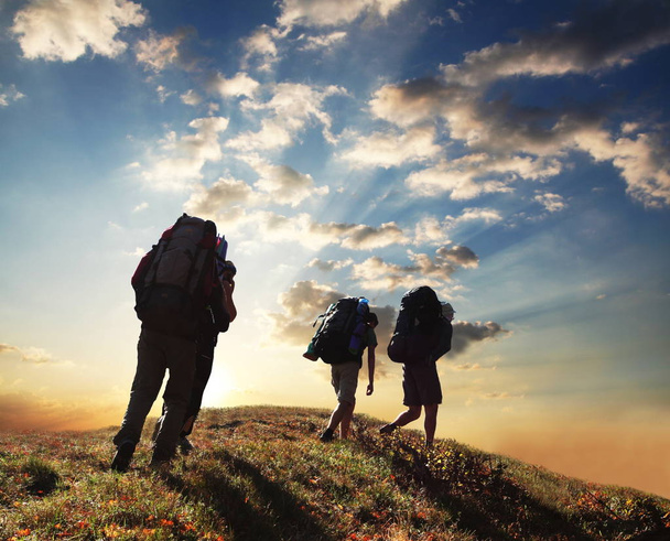 group of hikers with backpacks standing on the hill - Fotoğraf, Görsel