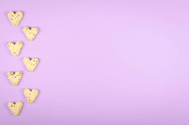 Flax seed cookies on purple background composition, heart shape. - Photo, Image