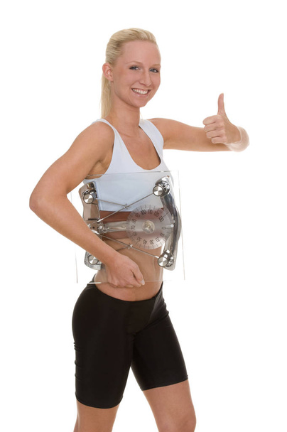 young woman in fitness wear showing thumbs up - Foto, immagini