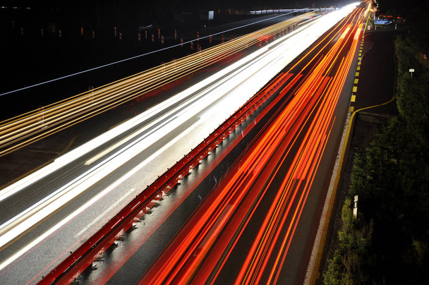 highway road at night, long term exposure - Фото, изображение