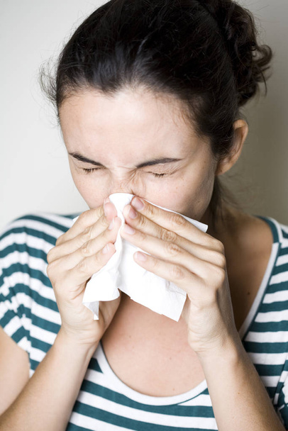 Woman sneezes with a scarf - Zdjęcie, obraz