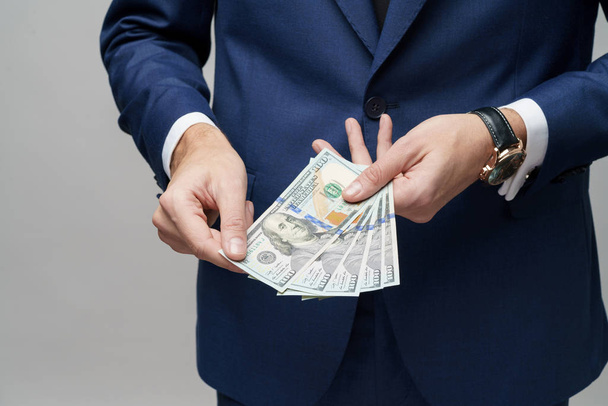 young handsome businessman holding US dollar bills - Foto, Imagem