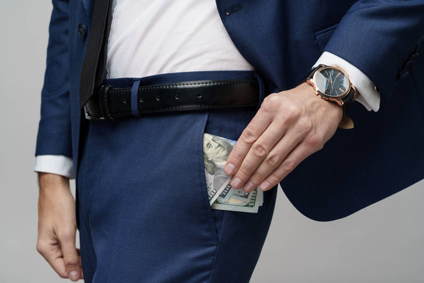 young handsome businessman holding US dollar bills - Foto, imagen