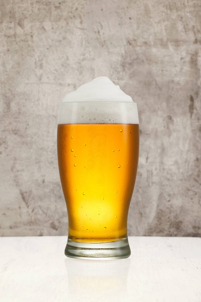 Beer splash in glass on vintage background with copy space - Photo, Image