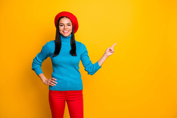 Portrait of her she nice attractive lovely cheerful cheery girl pointing forefinger aside ad advert decision solution isolated over bright vivid shine vibrant yellow color background - 写真・画像