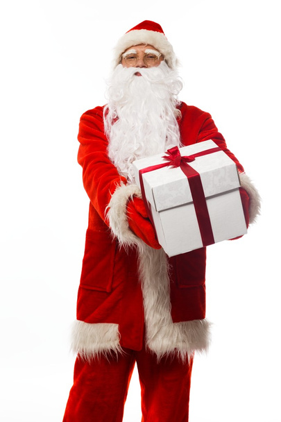 Santa Claus presenting gift box isolated on white background - Photo, image