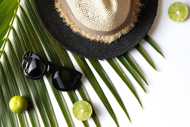 Composición de verano con frutas, sombrero y hoja de palma tropical en wh
 - Foto, imagen