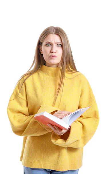 Emotional young woman with book on white background - Foto, imagen