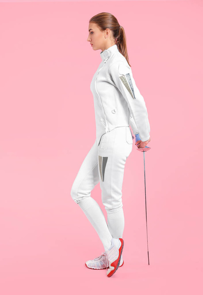 Young female fencer on color background - Photo, Image