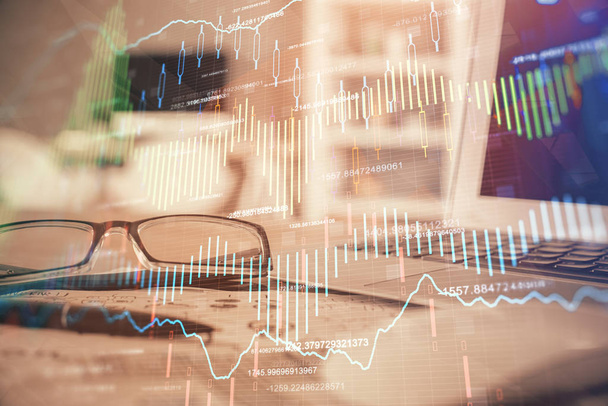 Financial chart hologram with glasses on the table background. Concept of business. Double exposure. - Photo, Image