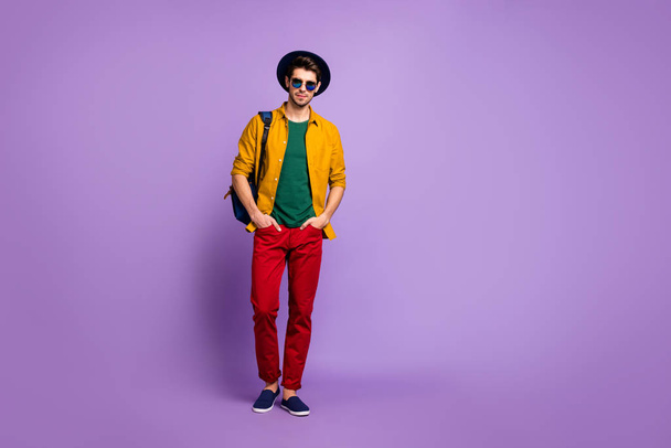 Full length photo of masculine rich wealthy guy have rest spring relax walk hold blue backpack wear retro stylish clothing velvet headwear isolated over violet color background - Φωτογραφία, εικόνα