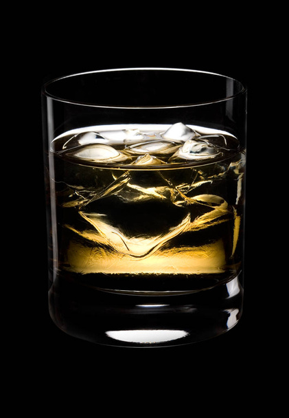 Glass of whisky with ice on a black background   - Zdjęcie, obraz