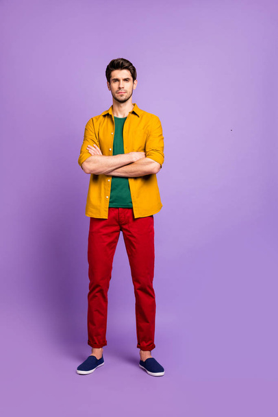 Vertical full length body size photo of serious pensive thoughtful man staring at you intently listening to information you tell isolated violet pastel color background - Zdjęcie, obraz