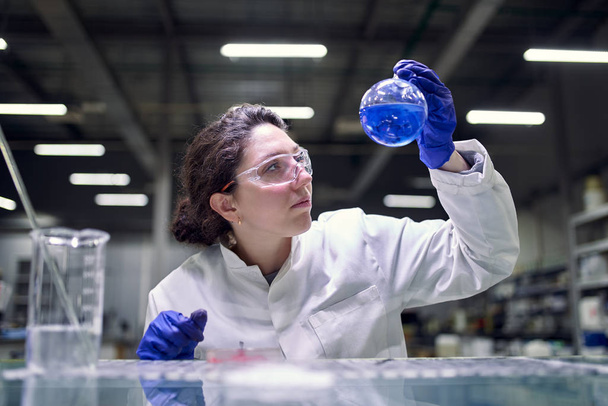 Young brunette laboratory assistant with petri dish in hands - Foto, Bild