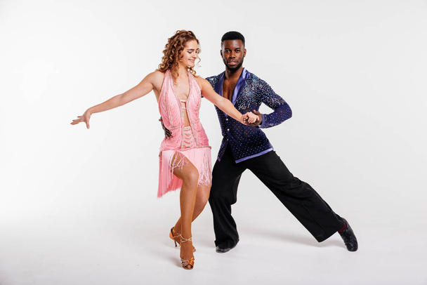 Black man and white woman dancing couple, fitness concept. Dancers on a white background - 写真・画像
