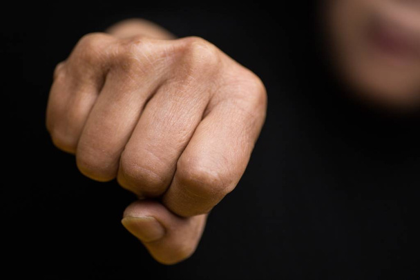 A closeup shot of a Chinese female holding her fist as a sign of strength-women empowerment concept - Φωτογραφία, εικόνα