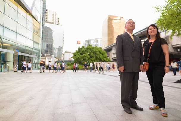 Portrait of mature Japanese businessman and mature Japanese woman exploring the city of Bangkok - Φωτογραφία, εικόνα