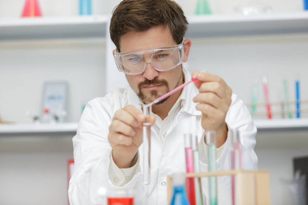 handsome student of chemistry working with chemicals - Photo, image