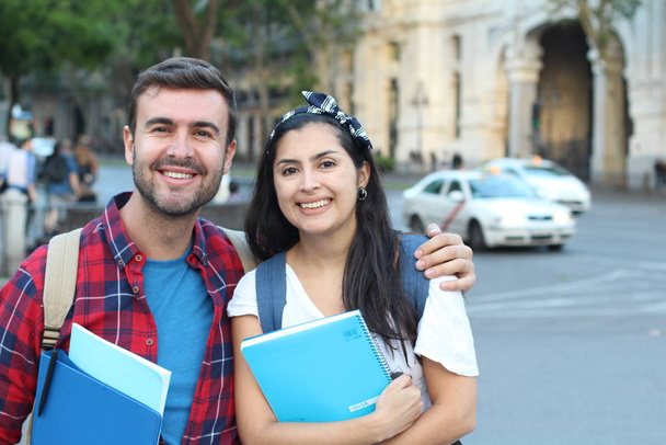 Two mixed race students smiling outdoors - Photo, Image