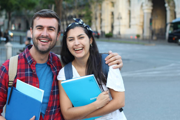 Two mixed race students smiling outdoors - Photo, Image