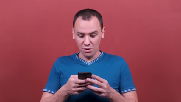 man Looking surprised wow, using mobile cell phone. man emotion isolated. People sincere emotions, lifestyle concept. - Video
