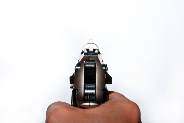 a man's hand holding a gun on a white background - Fotó, kép