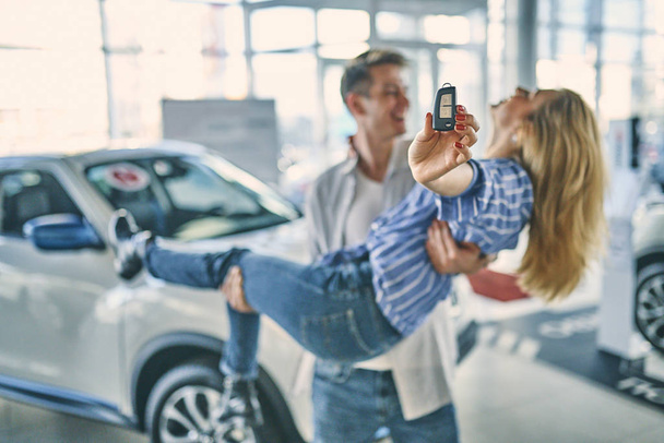 Happy couple having fun after buying a new car. - Foto, Imagem