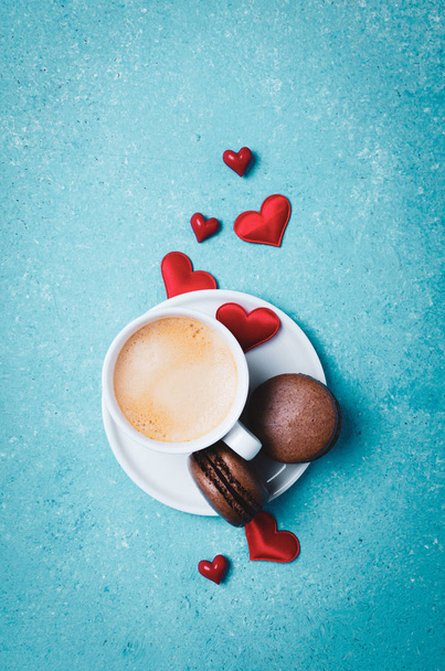 Cup of coffee and  macarons.  Colorful turquoise background. - Foto, imagen