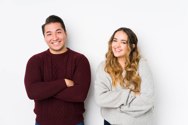 Young couple posing in a white background laughing and having fun. - Photo, Image