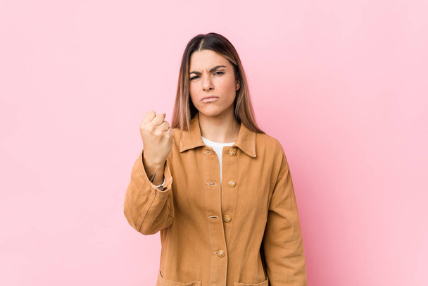 Young caucasian woman isolated showing fist to camera, aggressive facial expression. - Fotoğraf, Görsel