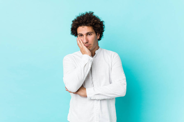 Young curly mature man wearing an elegant shirt who is bored, fatigued and need a relax day. - Foto, imagen