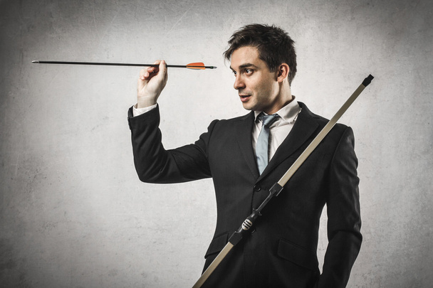 Businessman with bow and arrow - Foto, Imagen