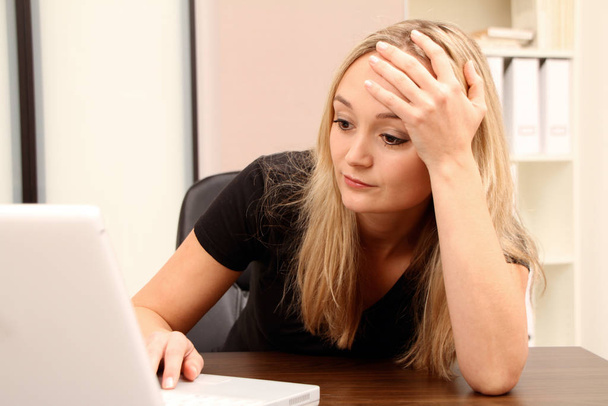 sad woman with laptop at home - Фото, зображення