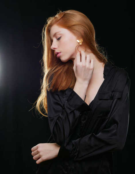 young girl with long red hair on a black background - Foto, immagini