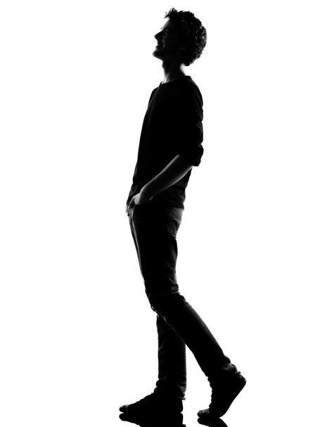 young man silhouette walking happy laughing - Valokuva, kuva