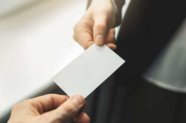 close up of people swapping blank business card. mockup - Fotoğraf, Görsel