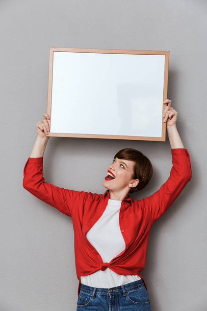 Image of attractive woman holding copyspace text board above her - Foto, imagen